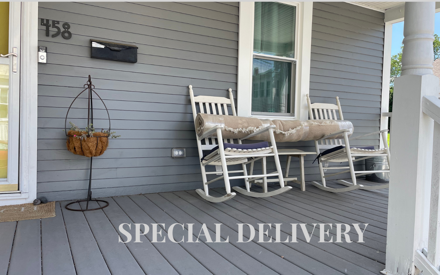 coule of rocking chairs with a rolled up rug